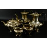 A George V silver five piece tea set by Walker & Hall, with shaped body, ebonised handle and knop to