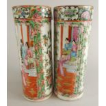 A pair of Chinese famille vert vases, each heavily decorated with figures in interior settings and