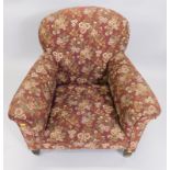 A late Victorian mahogany framed armchair, with squat supports, upholstered in (later) floral