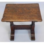 A mahogany coffee table, the rectangular shaped top on turned end supports, 51cm wide.