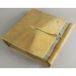 An early 20thC pig skin lined folder, containing a quantity of emery style pages, 34cm high.