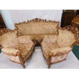 A Continental show timber rococo style three piece suite, the frame profusely carved with shell,