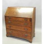 A George III oak bureau, the fall enclosing a fitted interior, above four graduated drawers, on