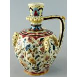 A late 19thC Zsolnay Pecs ceramic ewer, decorated with Islamic style flowers, leaves etc., in