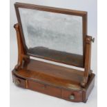 A early 19thC mahogany dressing table mirror, the rectangular plate on shaped end supports, the base