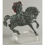 A Continental bronzed metal and polychrome decorated figure of a headless horseman, on a Perspex