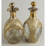 A pair of late 19th/early 20thC dimple style glass decanter bottles, each with a filigree brass