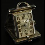 A Swiss miniature sterling silver travelling timepiece, the rectangular dial with dauphin hands