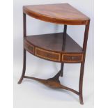 An early 19thC mahogany and tulip wood crossbanded corner washstand, the solid top with a moulded