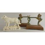 A pair of cast iron Empire style firedogs, each later painted and a St Bernard doorstop