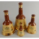 Four Bells whisky decanters, each containing 70% proof whisky, the largest 26? floz.