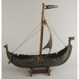 An ebonised brass and gilt metal model of a Viking longboat, with sail, 40cm long