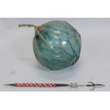 A large glass sea float or weight and an African tribal type spear, with beadwork handle.