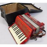 A Pietro red Bakelite type piano accordion, in canvas case.