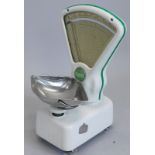 A set of Avery shop scales, in white enamel with green embellishment, 52cm high.
