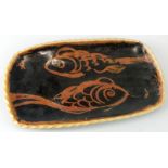 A Winchcombe Studio pottery rectangular dish, decorated with two copper lustre fish within an