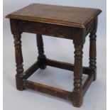 An oak joint stool, with a carved frieze on turned supports, 45cm high.