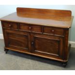 A Victorian low side cabinet, with a raised back above three drawers, two panelled doors on bun feet