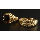 Two dress rings, to include a 9ct gold pierced design ring, and a red stone set yellow metal ring,