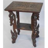 An early 20thC oriental hardwood two tier table, carved with leaves on pierced supports, 50cm wide.