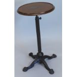 A Victorian bronzed cast iron and mahogany adjustable table, the circular top with a dished edge