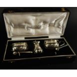 An Indian silver three piece cruet, comprising of a pair of open salts, a mustard pot and a pepper