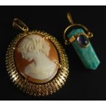 Two pendants, to include an Egyptian style pendant and a cameo in gold plated frame.