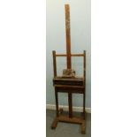 An early 20thC adjustable beech easel, 58cm wide.