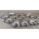 A mid 19thC Staffordshire part tea service, printed and painted in Oriental style with figures, to