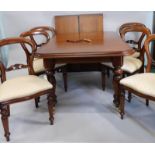 A Victorian style wind out extending dining table, the top with a moulded edge with two leaves on