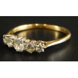 A five stone dress ring, set with white stones, on yellow metal band, unmarked, 2.1g all in.