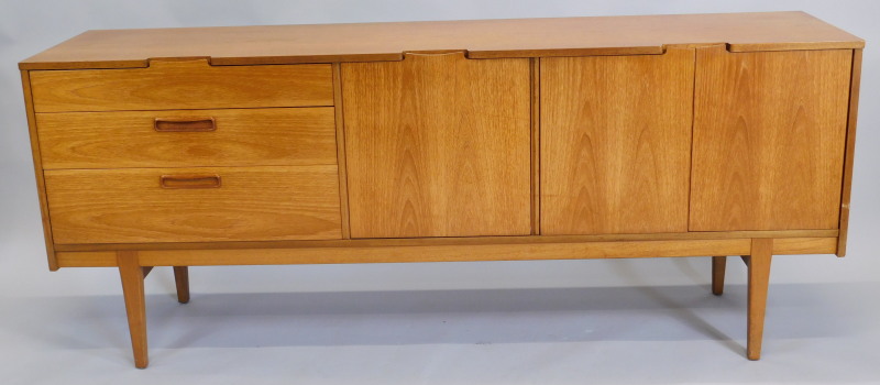 A 1967 Nathan Corsica teak sideboard, with three drawers, a fall front door and a pair of doors on