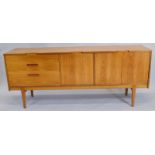 A 1967 Nathan Corsica teak sideboard, with three drawers, a fall front door and a pair of doors on