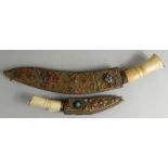 An Eastern ceremonial kukri, and another similar each with a bone handle and applied brass