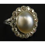 A pearl and diamond dress ring, the central cultured pearl, surrounded by sixteen round brilliant