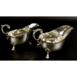 A pair of late Victorian silver sauce boats, each with a scroll handle and shell cast feet,