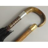 An Edwardian and gentleman's umbrella, the turned wood and horn handle with silver collar, and a