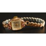 A ladies cocktail watch, with square dial, surrounded by six garnet stones, the case marked 14K,