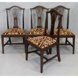 A set of four mahogany dining chairs, in George III style, each with pierced splats and drop in