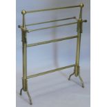 A late 19th/early 20thC cylindrical brass towel rail, on splayed legs, 67cm wide.