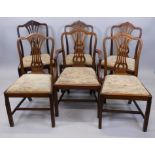 An associated set of six mahogany dining chairs in George III style, each with a pierced splat, drop