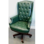 A green leather swivel office chair, with a padded back and seat.