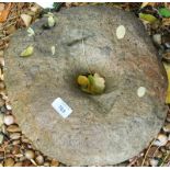A medieval grinding stone, 31cm dia., sold with museum authenticity.