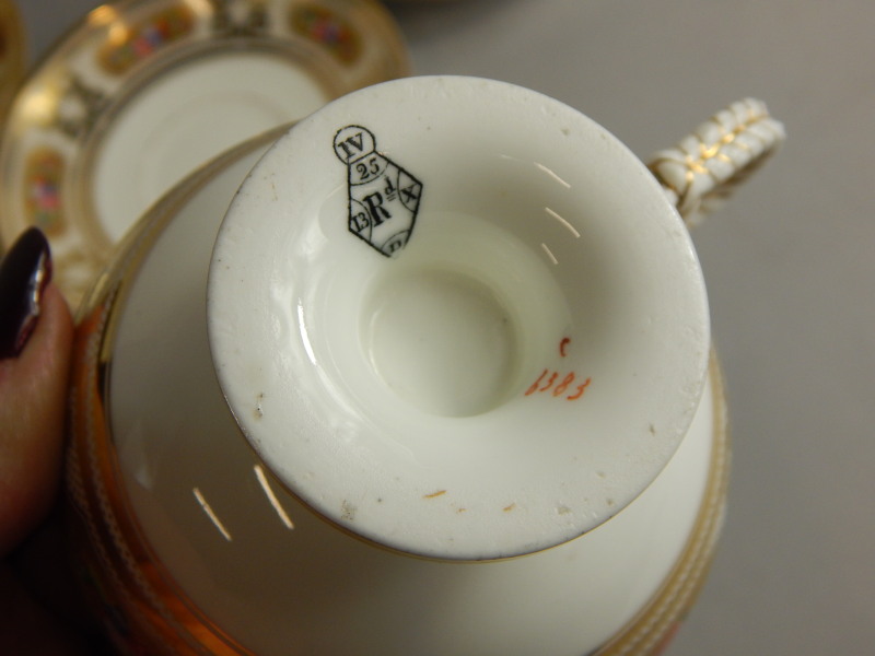 Three Victorian porcelain cups and saucers, each decorated with flowers within elaborate gilt - Image 2 of 2