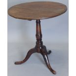 A 19thC oak and beech occasional table, the circular tilt top on a turned column and a tripod
