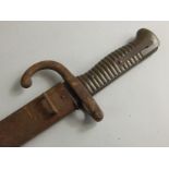 A 19thC 1872 model bayonet and scabbard, with shaped partially engraved blade, turned handle and