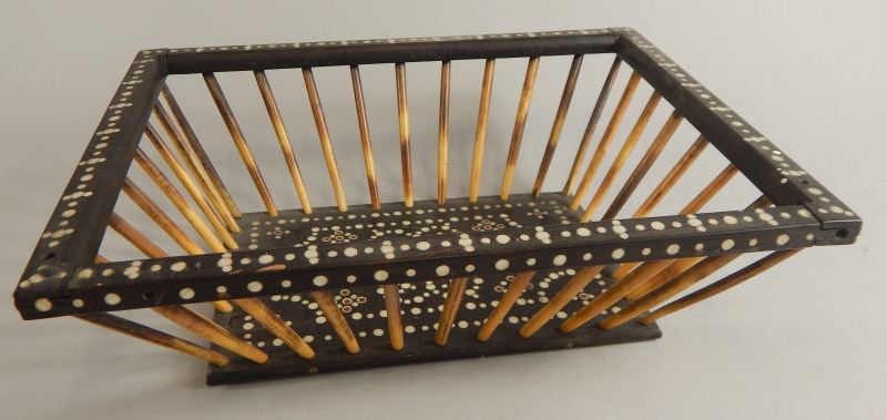 An early 19thC Anglo Indian ebony ivory and porcupine quill basket, of tapering form, 26cm wide. (