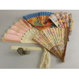 A collection of fans, to include silk example with pierced ivory sticks, a silver plated oriental