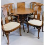 A retro style G-Plan type teak extending dining table and six chairs, each with a rail back and