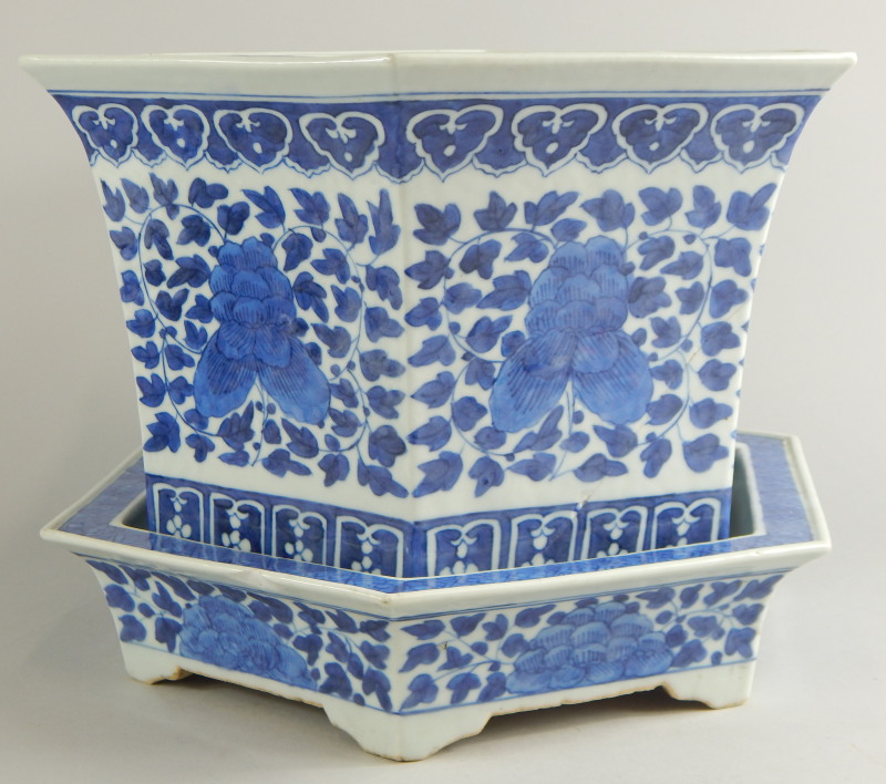 A Chinese blue and white porcelain hexagonal jardiniere and stand, decorated with flowers and